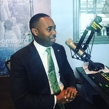 David Burt In Dark Suit Speaking In A Radio Station