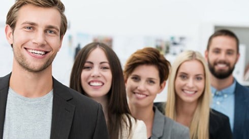 Five young business professionals smiling