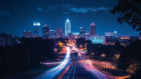 skyline of Raleigh North Carolina at night with neon lights