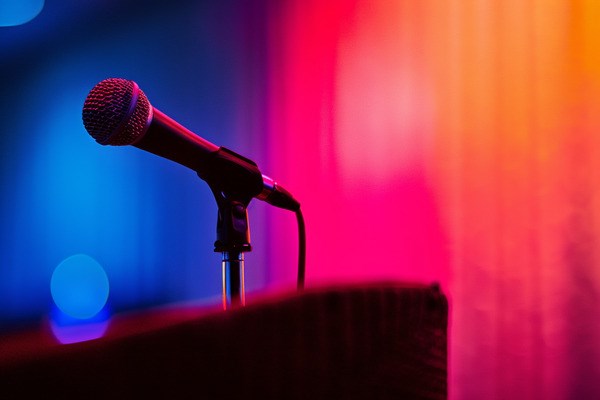 A close up photo of a microphone on a podium.