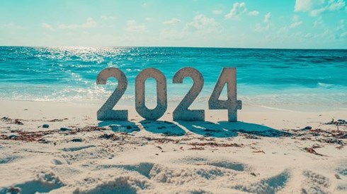 The number 2024 on a beach with white sand and turquoise water