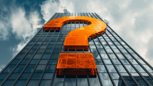 An orange question mark on the side of a skyscraper