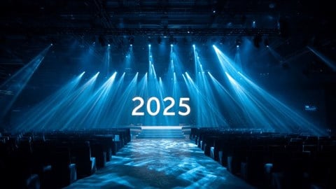 The number 2025 on a stage with spotlights shining above it