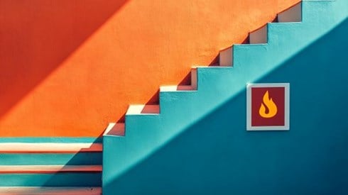 blue and orange stairs over a danger sign