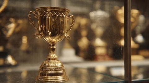 A gold trophy in a trophy case