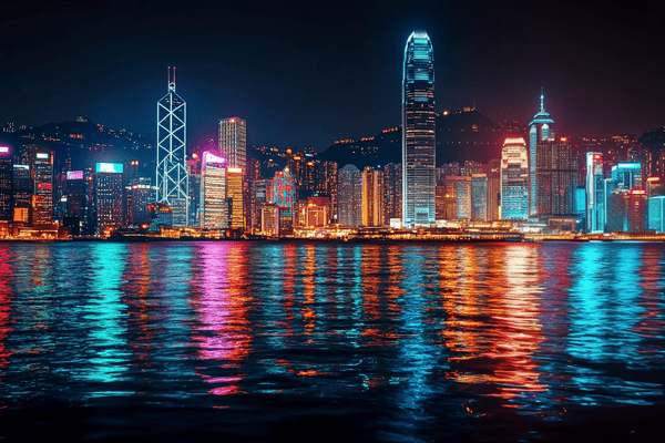 Downtown Hong Kong at night, with its colorful lights reflecting in the water