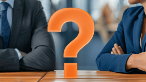 Businessman and adviser sitiing at a table with an orange question mark between them