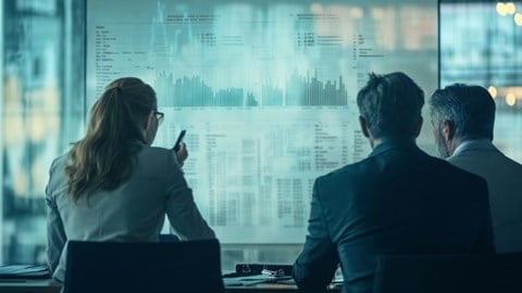 three businesspeople looking at data on a whiteboard