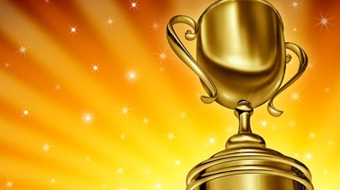 Gold award trophy with stars in background