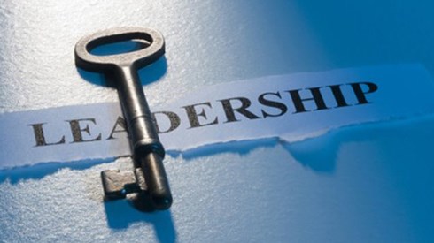 A skeleton key lying on top of the word LEADERSHIP