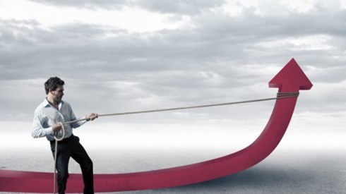 A man has tied a rope right below the arrowhead of a giant red thick graph line and is pulling the arrow up toward the sky