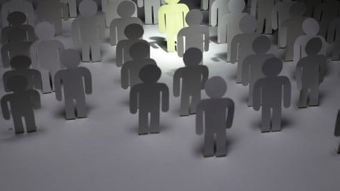 People figures In gray with one standing out in light green