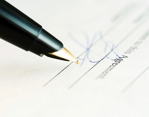 Pen next to a signature on a legal document  