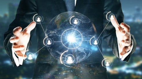 Businessman with arms out holding a white hologram of a sphere with several connecting dots