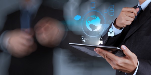 Businessman holding tablet emitting a blue hologram of earth with security icons