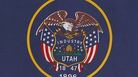 Utah flag--navy blue background, gold circle with eagle, flag, Industry, Utah, 1847, 1896 inside