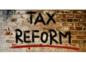 The words TAX REFORM are spray painted on a deteriorating brick wall