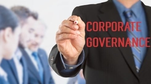 Businessman writing Corporate Governance