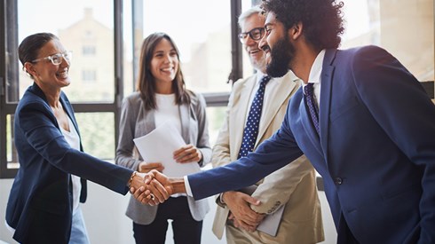 Business colleagues shaking hands in a meeting