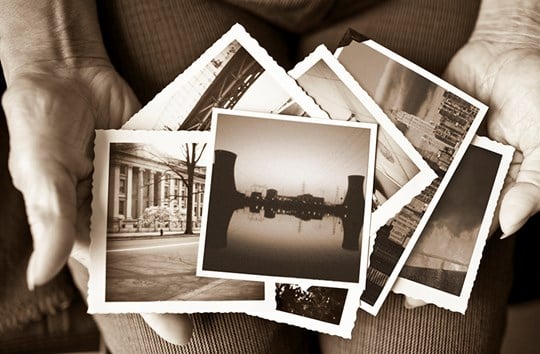 Woman's hands holding old historical pohotos